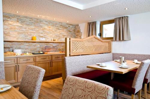 a kitchen with a table and chairs in a kitchen at Apart Schneider in Ischgl