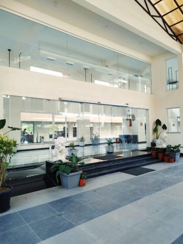 a large building with many windows and potted plants at Regenta Central North Goa, Arpora in Arpora