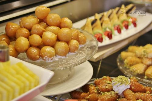 a buffet filled with plates of food on display at Carawan Al Fahad Hotel in Riyadh
