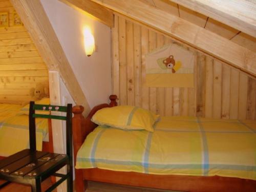 a bedroom with a yellow bed in a room at Ker Carlit in Saint-Pierre-dels-Forcats