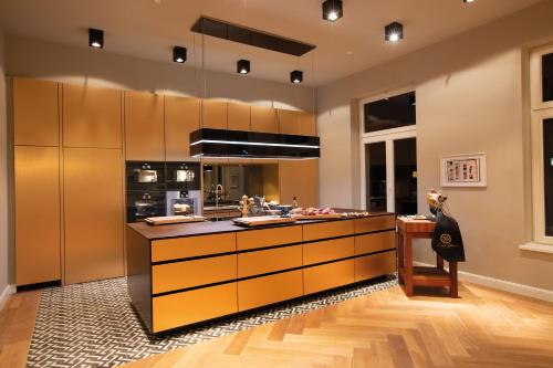 a large kitchen with a counter and a stove at Villa Glanzstoff in Heinsberg