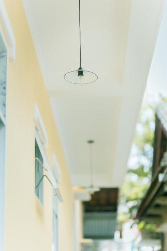 a light fixture hanging from the side of a building at Tùng Homestay in Hue