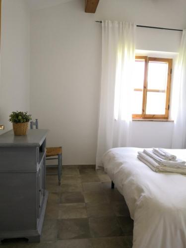 Кровать или кровати в номере Maremma Country Chic Le Ginestre