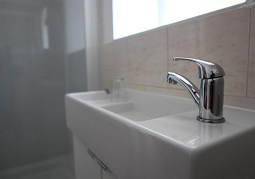 a bathroom with a sink and a mirror at Hotel 261 in London