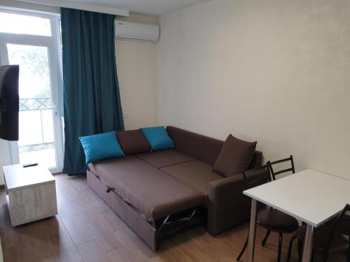 a living room with a couch and a table at Apartment near the Beach Batumi-Gonio in Gonio