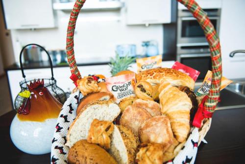 a basket of bread and pastries on a table at Clovenstone Lodges in Inverurie