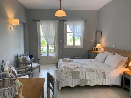 a bedroom with a bed and a table and chairs at Kiki Studios in Fiskardo