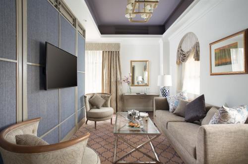 a living room with a couch and a tv at Concorde El Salam Cairo Hotel & Casino in Cairo
