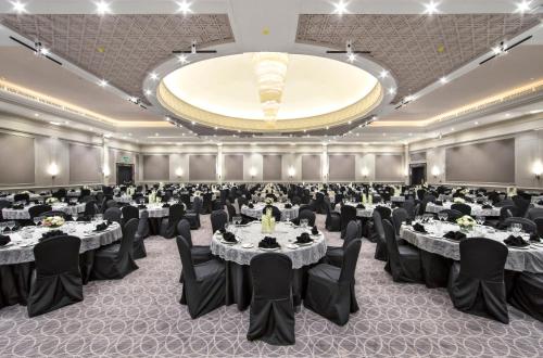 a banquet hall with tables and chairs and a large ceiling at Concorde El Salam Cairo Hotel & Casino in Cairo
