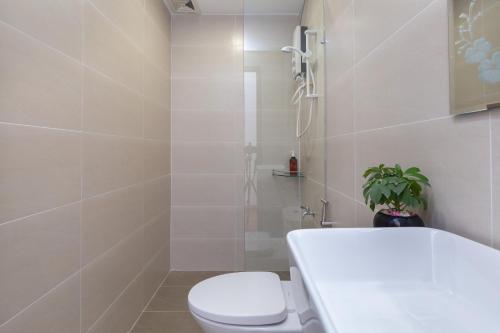 a bathroom with a toilet and a bath tub at Cozrum Homes Lý Chính Thắng in Ho Chi Minh City