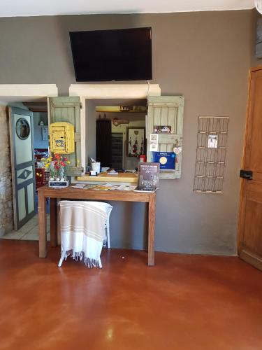 a wooden table in a room with a mirror at Le Crillon in Murs