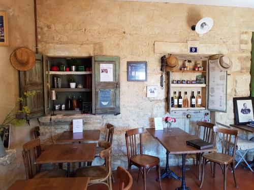 a restaurant with wooden tables and chairs in a room at Le Crillon in Murs