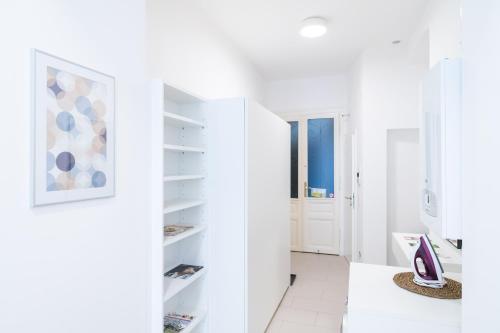 a white room with white shelves and a hallway at Luxury Suites Liechtenstein in Vienna