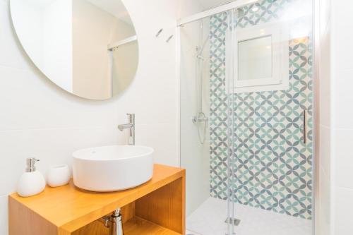 a bathroom with a sink and a shower at Riandgo in Port d'Alcudia