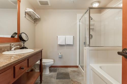 a bathroom with a toilet and a sink and a shower at Village 1402 in Mammoth Lakes