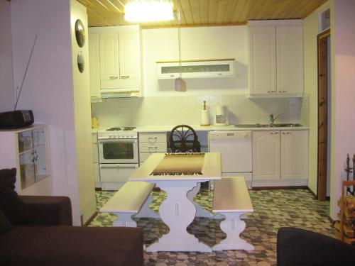 a kitchen with a table with a keyboard in it at MukaLilla in Ukkohalla