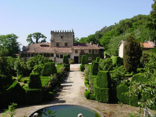 a view of a garden with a castle in the background at Paço de S.Cipriano in Guimarães