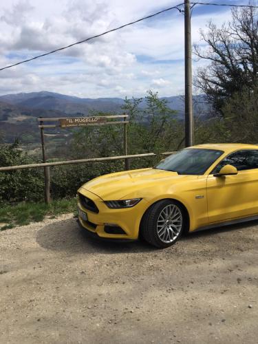 a yellow car parked on the side of a road at Il Mugello B&B in Vicchio