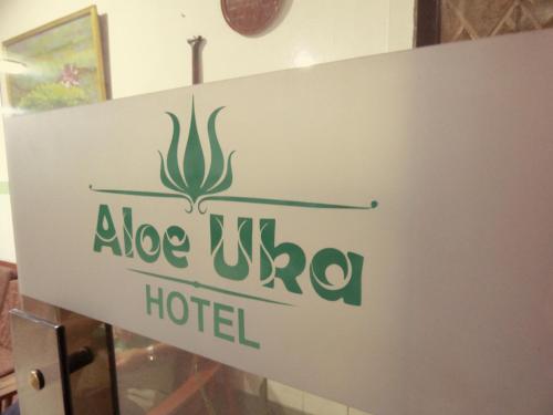 a sign on the door of a hotel at Hotel Aloe Uka in Iquitos