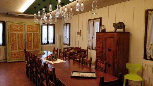 a dining room with a large wooden table and chairs at Agriturismo Gazza Ladra in Noventa di Piave