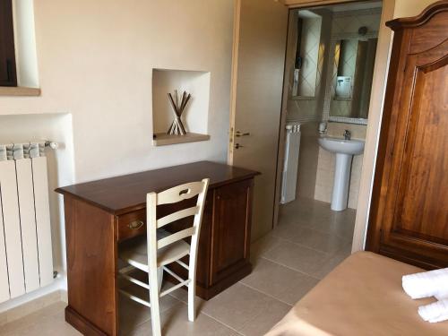 a bathroom with a wooden counter and a sink at Tenuta De Luca in Sannicandro Garganico