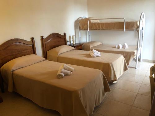 a hotel room with two beds with towels on them at Tenuta De Luca in Sannicandro Garganico