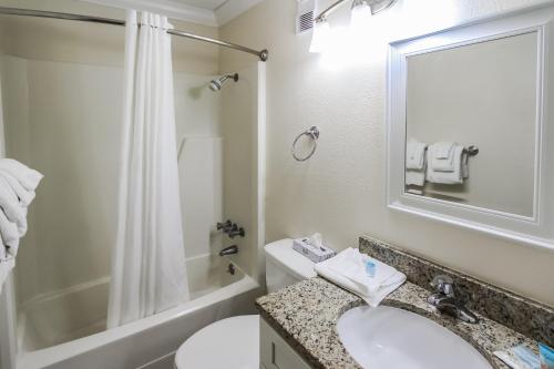 a bathroom with a sink and a toilet and a shower at A Place at the Beach III in Atlantic Beach