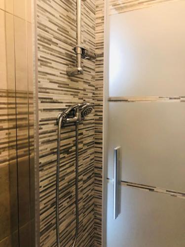 a shower in a bathroom with a glass door at La casa di Chloé in Alezio