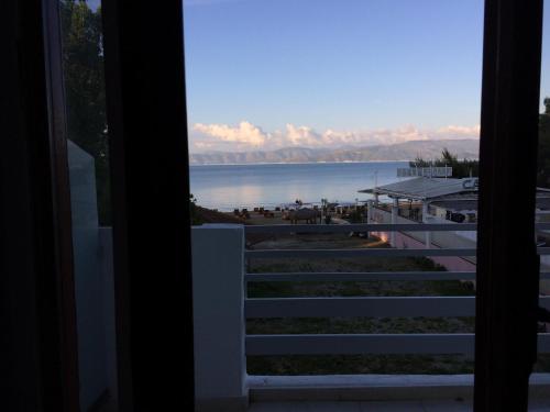 a view of the water from the balcony of a house at Hebes on the beach in Kavos