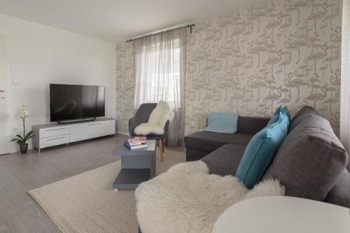 a living room with a couch and a tv at Apartma Bled in Bled