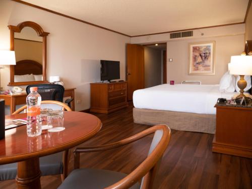 a hotel room with a bed and a table at Crowne Plaza Hotel Monterrey, an IHG Hotel in Monterrey