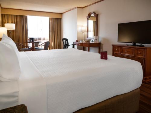 a hotel room with a large bed and a television at Crowne Plaza Hotel Monterrey, an IHG Hotel in Monterrey