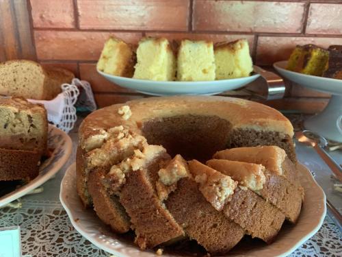 a loaf of bread on a table with other cakes at Pousada Penedo in Penedo