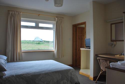 a hotel room with a bed and a window at Kemar House post code F26RR28 in Belmullet