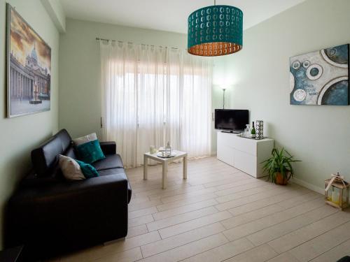 a living room with a couch and a tv at Saint Peter Welcoming Apartment in Rome