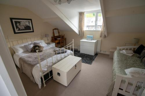 a bedroom with a bed with a dog laying on it at Bracken Crag in Bowness-on-Windermere