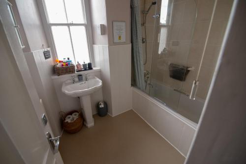 a bathroom with a sink and a shower and a toilet at Bracken Crag in Bowness-on-Windermere