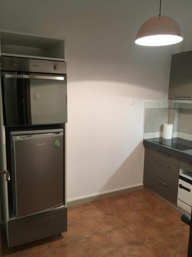 a kitchen with a refrigerator and a counter top at Joges 2 in Athens