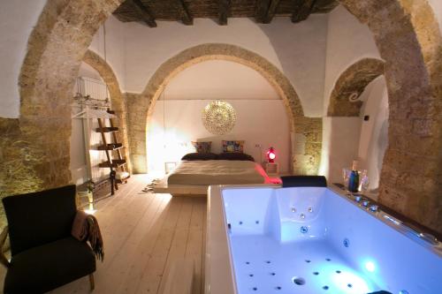 a large bathroom with a tub in the middle of a room at AL TEMPO SOSPESO in Gioia del Colle