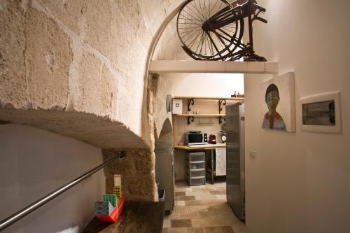 a hallway of a kitchen with a bicycle on the wall at AL TEMPO SOSPESO in Gioia del Colle