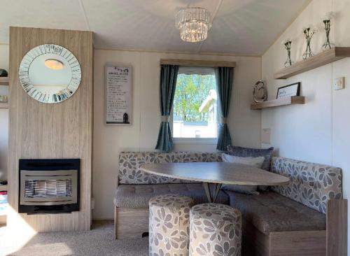 a living room with a table and a couch at Edinburgh, seton sands in Port Seton