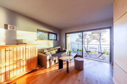 a living room with a couch and a table at Lauču Akmens in Skulte