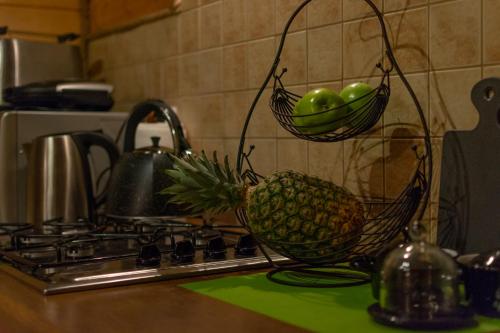 a pineapple sitting on a counter next to a stove at Chaty Anety Domki Całoroczne in Solina