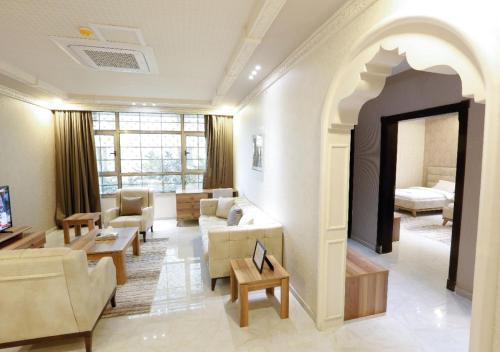 a living room filled with furniture and a fireplace at Four Seasons Suites in Taif