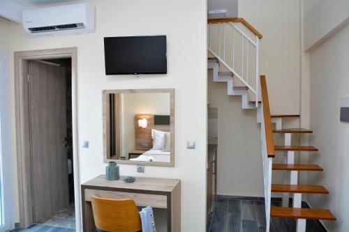 a living room with a staircase and a mirror at Vasilicos Sea Stay in Paralia Katerinis