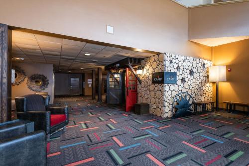a lobby with a waiting room with a couch and chairs at Grand Summit Hotel in Newry