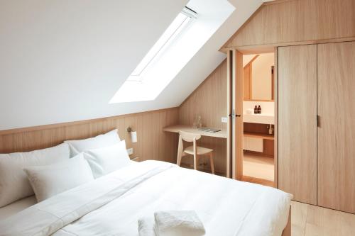 Un pat sau paturi într-o cameră la Pommiers Sauvages - Ellezelles