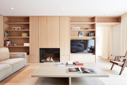 a living room with a couch and a fireplace at Pommiers Sauvages - Ellezelles in Ellezelles