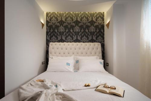 a bedroom with a bed with two shoes on it at Pela Veranda Exquisite Suites in Neos Marmaras
