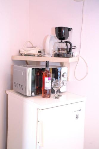 a microwave sitting on top of a refrigerator at Nontas Home in Kalamitsi